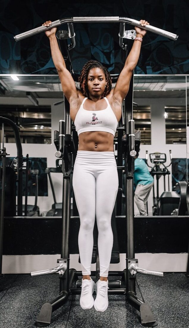 woman in white tank top and white pants doing exercise